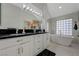 Bathroom features a soaking tub and double sinks with granite countertops at 8591 Heather Downs Dr, Las Vegas, NV 89113
