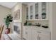 Close up on a dining area with a fireplace and built in cabinets with display shelving at 8591 Heather Downs Dr, Las Vegas, NV 89113