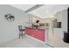 Well-lit kitchen with counter seating, granite countertop, and modern appliances at 8591 Heather Downs Dr, Las Vegas, NV 89113