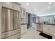 Open concept kitchen features stainless steel appliances, white cabinets, and tile flooring at 8591 Heather Downs Dr, Las Vegas, NV 89113