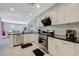 Spacious kitchen featuring stainless steel appliances, white cabinets, and tile flooring at 8591 Heather Downs Dr, Las Vegas, NV 89113