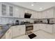 Well-lit kitchen features white cabinets, stainless steel appliances, and black countertops at 8591 Heather Downs Dr, Las Vegas, NV 89113