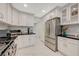 Beautiful kitchen with stainless steel appliances and white cabinets with tile flooring at 8591 Heather Downs Dr, Las Vegas, NV 89113