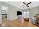 Cozy living room with wood floors, a modern ceiling fan, and sliding glass doors to a balcony at 8591 Heather Downs Dr, Las Vegas, NV 89113