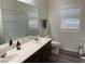Bright bathroom featuring double sinks, and a shower over tub combo at 8805 Jeffreys St # 1103, Las Vegas, NV 89123