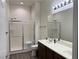 Bright bathroom features a double sink vanity, a shower, and a large mirror at 8805 Jeffreys St # 1103, Las Vegas, NV 89123