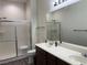 Bathroom with double sink vanity, enclosed shower, and stylish lighting at 8805 Jeffreys St # 1103, Las Vegas, NV 89123