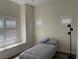 This bedroom includes luxury vinyl floors, a ceiling fan, and natural light at 8805 Jeffreys St # 1103, Las Vegas, NV 89123