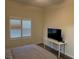 Bedroom featuring a TV and a bright window with wooden look flooring at 8805 Jeffreys St # 1103, Las Vegas, NV 89123