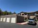 Apartment complex exterior featuring garages, covered parking, and convenient staircase access to the units at 8805 Jeffreys St # 1103, Las Vegas, NV 89123