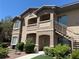 Inviting multi-story exterior showcasing a well-manicured lawn and convenient staircase access to upper-level units at 8805 Jeffreys St # 1103, Las Vegas, NV 89123