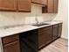 This kitchen features wood cabinets, a stainless steel sink, and laminate countertops at 8805 Jeffreys St # 1103, Las Vegas, NV 89123