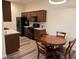 Kitchen with dark wood cabinets, stainless steel appliances, and adjacent dining area at 8805 Jeffreys St # 1103, Las Vegas, NV 89123