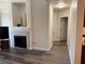 Living room showcasing a modern fireplace, an open floor plan, and wood-look floors at 8805 Jeffreys St # 1103, Las Vegas, NV 89123