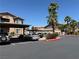Apartment complex parking area, featuring covered parking, mature landscaping, and multiple parking spaces at 8805 Jeffreys St # 1103, Las Vegas, NV 89123