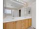 Bathroom featuring double sinks, large mirror, shower, and closet at 8913 Loggers Mill Ave, Las Vegas, NV 89143