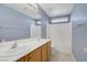 Bathroom features a double sink vanity, large mirror, and combined shower and bathtub at 8913 Loggers Mill Ave, Las Vegas, NV 89143