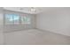 Bright bedroom boasts neutral carpeting and large windows with beautiful outdoor views at 8913 Loggers Mill Ave, Las Vegas, NV 89143