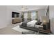 Comfortable bedroom with a large window, soft carpet, and a cozy atmosphere at 8913 Loggers Mill Ave, Las Vegas, NV 89143