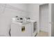 Laundry room with modern washer and dryer and built-in shelving for storage at 8913 Loggers Mill Ave, Las Vegas, NV 89143