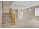 Spacious living room featuring a staircase, tile floors, and ample windows at 8913 Loggers Mill Ave, Las Vegas, NV 89143