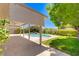 A covered patio overlooks a small, in-ground pool surrounded by well-maintained landscaping and greenery at 8913 Loggers Mill Ave, Las Vegas, NV 89143