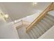 View of the carpeted staircase with wood railing from the upper level at 8913 Loggers Mill Ave, Las Vegas, NV 89143