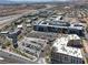 Panoramic aerial view of a mixed-use development with residential and commercial buildings, and ample parking at 9198 Harbin Ave, Las Vegas, NV 89148