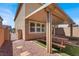 Backyard with covered patio featuring a wood picnic table and artificial grass at 9198 Harbin Ave, Las Vegas, NV 89148
