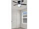Bedroom featuring a ceiling fan, window with blinds, and white door at 9198 Harbin Ave, Las Vegas, NV 89148