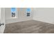 Bedroom featuring two windows, neutral carpet, and a white door at 9198 Harbin Ave, Las Vegas, NV 89148