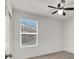 Bedroom featuring a ceiling fan, window with blinds, and white door at 9198 Harbin Ave, Las Vegas, NV 89148