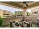Relaxing balcony with seating area and ceiling fan overlooking landscaped community at 9201 Tesoras Dr # 302, Las Vegas, NV 89144