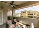 Spacious covered balcony with seating area overlooking common area with lush landscaping at 9201 Tesoras Dr # 302, Las Vegas, NV 89144