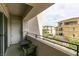 Spacious balcony with small table and seating overlooking landscaped community at 9201 Tesoras Dr # 302, Las Vegas, NV 89144