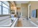 Bright bathroom featuring a large tub, glass block window, and separate shower at 9201 Tesoras Dr # 302, Las Vegas, NV 89144