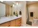 Bathroom with light wood cabinets, white countertops, tile flooring, and a walk-in shower at 9201 Tesoras Dr # 302, Las Vegas, NV 89144