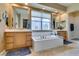 Bright bathroom featuring double vanity, large tub, and separate shower at 9201 Tesoras Dr # 302, Las Vegas, NV 89144