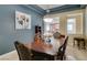 Traditional dining room with a wooden table and chairs, beautiful lighting fixture, and modern art at 9201 Tesoras Dr # 302, Las Vegas, NV 89144