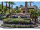 Stone sign in front of community entrance with lush green landscaping at 9201 Tesoras Dr # 302, Las Vegas, NV 89144