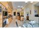 Open kitchen features stainless steel appliances, wooden cabinets, tile floors, and black countertops at 9201 Tesoras Dr # 302, Las Vegas, NV 89144