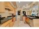 Well-lit kitchen with wood cabinets, stainless steel appliances, granite countertops, and tile flooring at 9201 Tesoras Dr # 302, Las Vegas, NV 89144