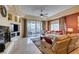Comfortable living room with a fireplace, TV, access to balcony and cozy seating at 9201 Tesoras Dr # 302, Las Vegas, NV 89144
