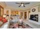 Inviting living room featuring a fireplace, ceiling fan, and neutral color palette at 9201 Tesoras Dr # 302, Las Vegas, NV 89144