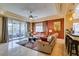 Cozy living room with fireplace, ceiling fan, access to a balcony and view of the community at 9201 Tesoras Dr # 302, Las Vegas, NV 89144