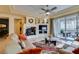 Bright living room with fireplace, ceiling fan, and balcony access for outdoor enjoyment at 9201 Tesoras Dr # 302, Las Vegas, NV 89144
