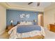 Spacious main bedroom featuring carpet flooring, a tray ceiling, and blue accent wall at 9201 Tesoras Dr # 302, Las Vegas, NV 89144
