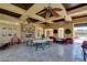 Outdoor patio with ceiling fans, stone fireplace, and seating area at 9201 Tesoras Dr # 302, Las Vegas, NV 89144