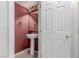 Small half bath featuring pedestal sink and tile floors at 9537 Michelle Falls Ave, Las Vegas, NV 89149