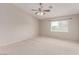 Spacious bedroom featuring neutral colored walls, carpet floors, and a ceiling fan at 9537 Michelle Falls Ave, Las Vegas, NV 89149
